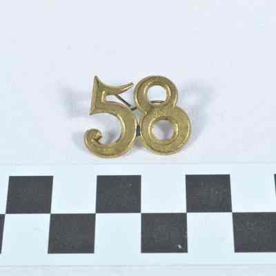 Regimental number stamped brass "58"