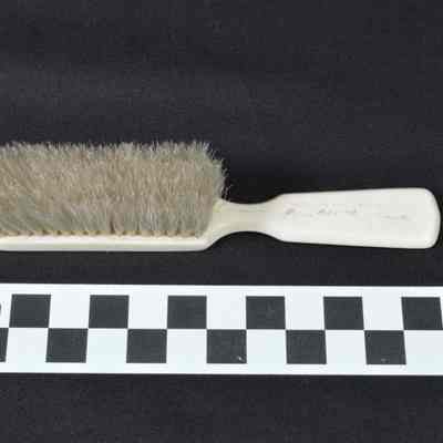 Doll hair brush with white handle