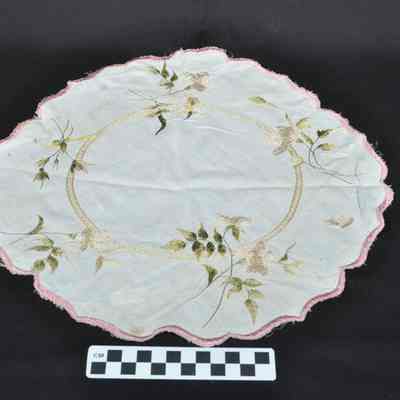 Round, white doily with pink border