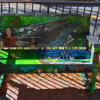 Bench with painting of Town Run and McMurran Hall