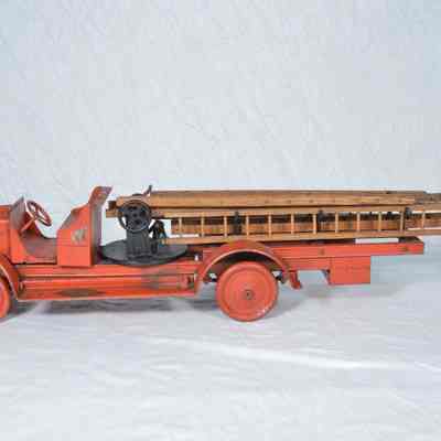 Wood and tin, red painted hook and ladder fire truck