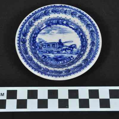 Blue and white china with horsedrawn railroad car in center