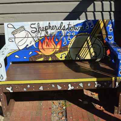 Bench with painted banjo, fire, and jar