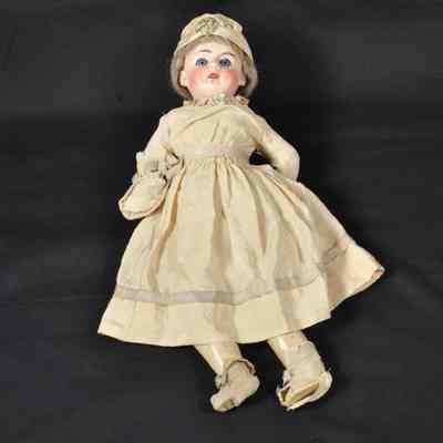 German bisque-head doll with yellow silk dress