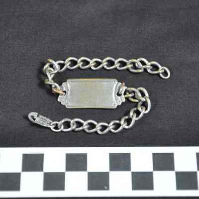 Silver colored identification bracelet with chain