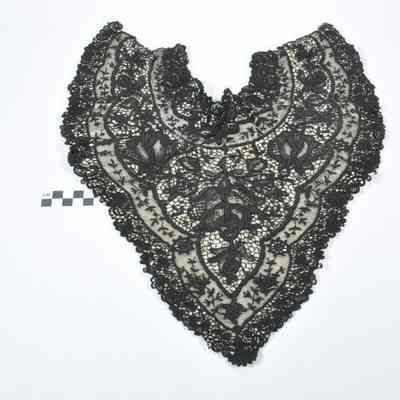 Black lace collar sewn onto a white backing