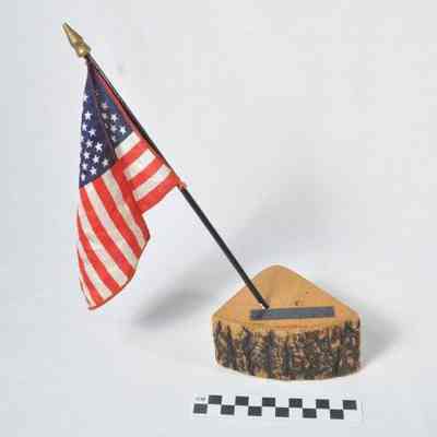 U.S.A. flag displayed on a slice of a tree trunk