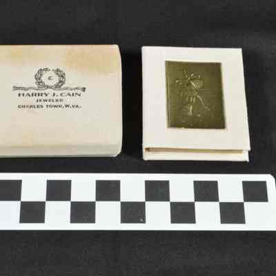 Small, white jewelers' box from Harry J. Cain's jewelry store