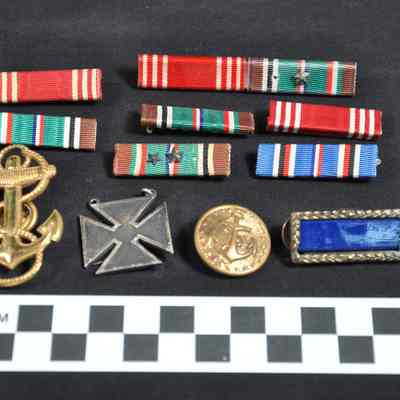 Collection of World War II service ribbons, insignia, and medals