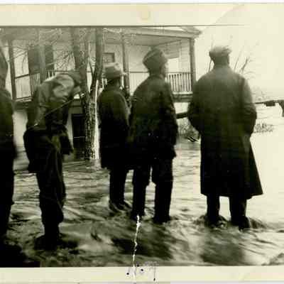 Men standing at foot of Princess Street watching as Potomac River Bridge is swept away during 1936 flood