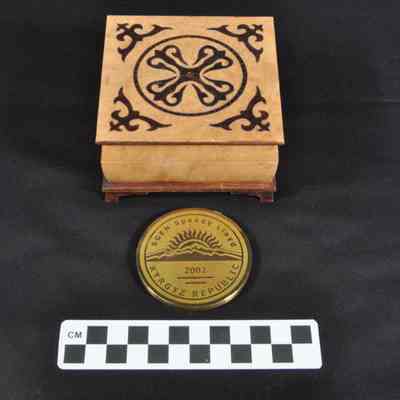 Bronze colored medal or coin in wooden presentation box