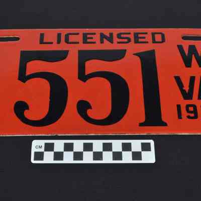 Red enameled license plate
