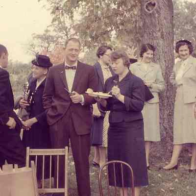 Individuals standing near a tree outside Uvilla Methodist Church (IMG3895001)