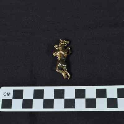 Brass pin shaped as jockey on a horse
