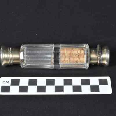 Two-ended cut glass perfume bottle with gold washed silver caps