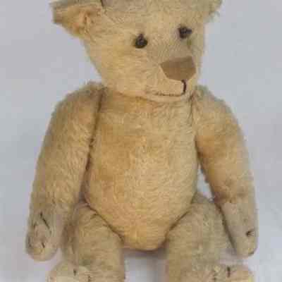 Bear with light tan cotton fur and black button eyes