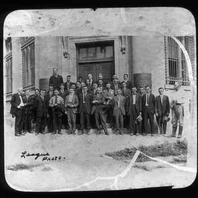 Group of men in front of Farmers and Merchants Bank