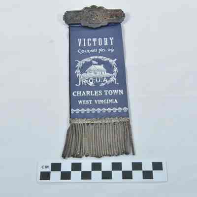 Two-sided ribbon with tin nameplate at top