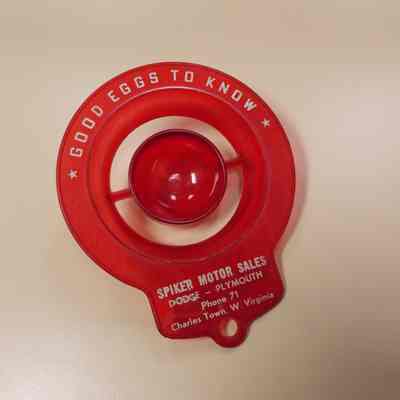 Red plastic egg separator advertising Spiker Motor Sales