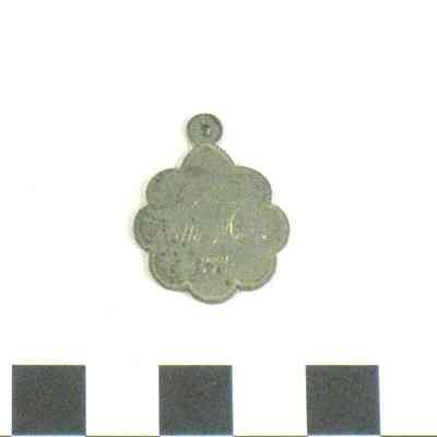 Round silver medallion with scalloped edges