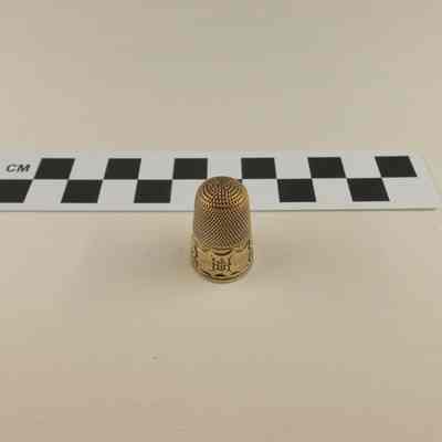 Brass colored thimble