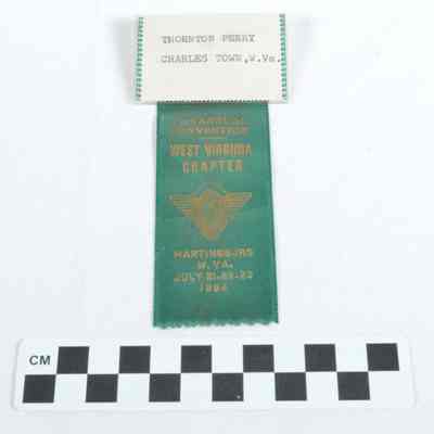 Green satin ribbon with name tag stapled to it