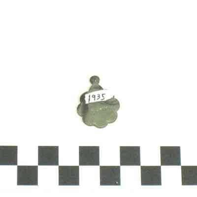 Round silver medallion with scalloped edges