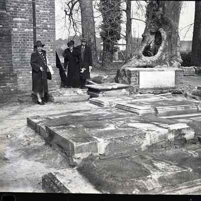 Nita Moore and unidentified man and woman at gravestones