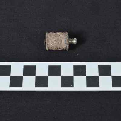 Tape measure in silver colored cylinder with raised bird and flower design