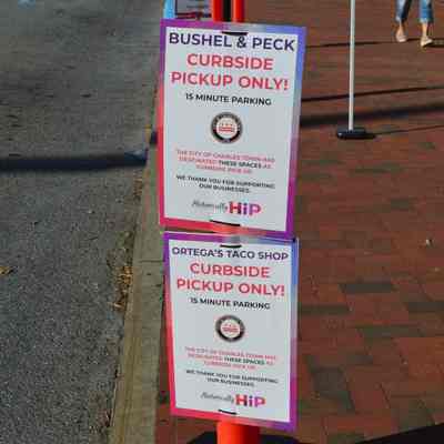 Curbside pickup signs for Bushel & Peck and Ortega's Taco Shop