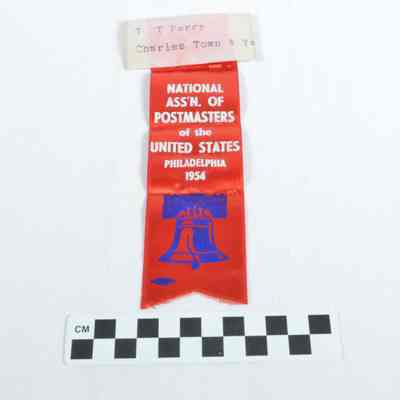 Red ribbon with name tag stapled to top