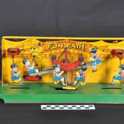 Tin mechanical toy with see-saw and swings
