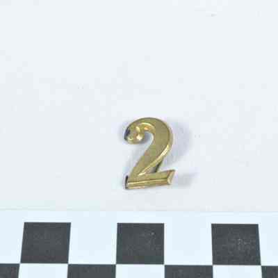 Regimental number stamped brass "2" hat badge
