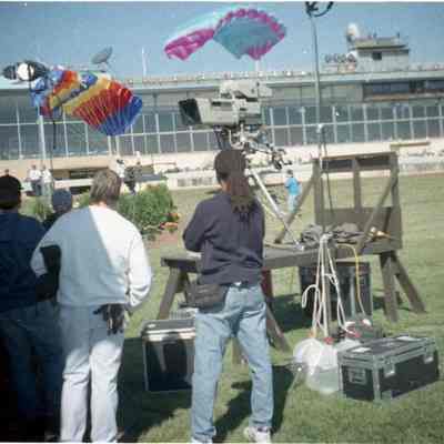 Individuals standing near camera in infield at Charles Town Race Track