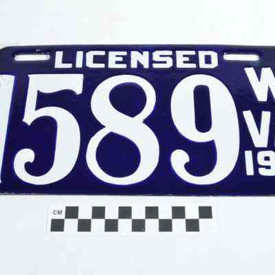 White numbers on dark blue enamel license plate