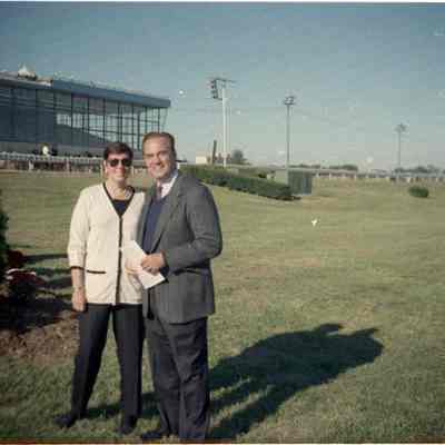 Women and Sam Huff standing in infield at Charles Town Race Track