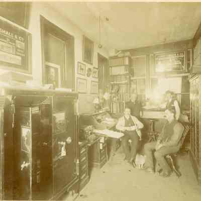 Four men in office of A. D. Goetz Harness Factory.