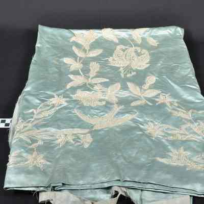 Light blue silk piece of material with beads sewn on in designs