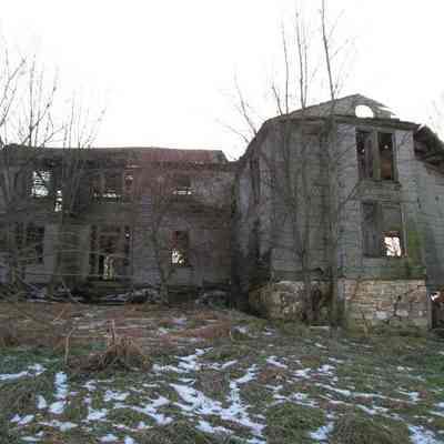 Front of house with original log cabin to the right