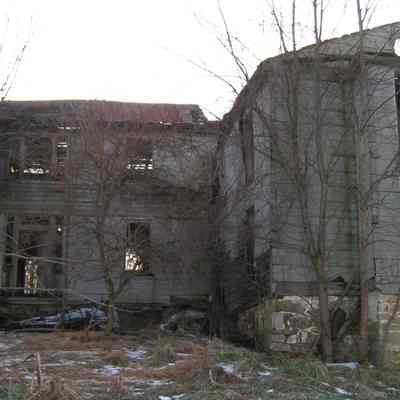 Front of house with original log cabin to the right