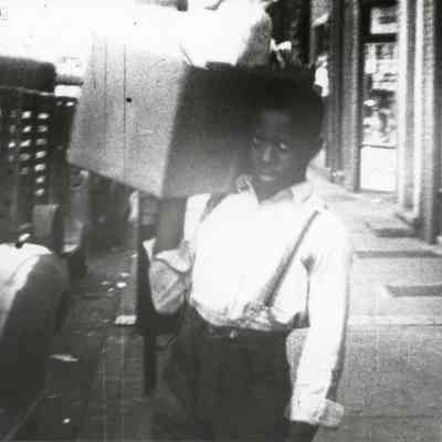 Young African American man loading truck