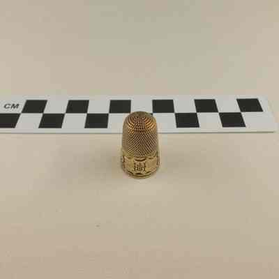 Brass colored thimble
