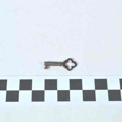 Key to multi-drawered,rectangular papier mache sewing cabinet