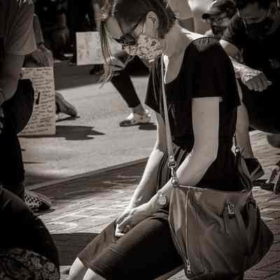 Woman wearing mask kneeling during Black Lives Matter rally (IMG3915021)
