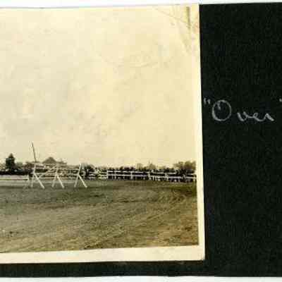 Horse and rider jumping over bar, "Over the top"