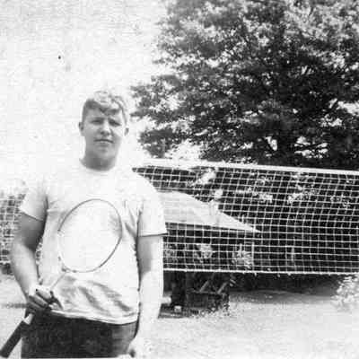 Harry Jenkins, Jr. holding a tennis racket