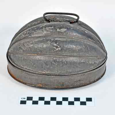 Two piece tin pudding mold in shape of a half cantaloupe