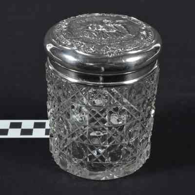 Cut glass container with silver top