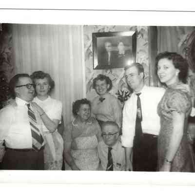 Interior of the home of Martin D. Welsh, Bakerton, WV. From L-R: Skeeter Welsh, Dorothy Webb-Welsh, Laura E. Lewis Welsh, Lois J. Stickley, Martin D. Welsh, Sr., Bobby L. Welsh, June D. Eaton Welsh. Photo on wall is of Tommy B. Walsh and Maggie V. Flanagan Welsh: IMG2025.026.001 (16)