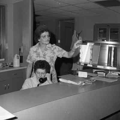 UNK (seated) and Marie Mason (standing)